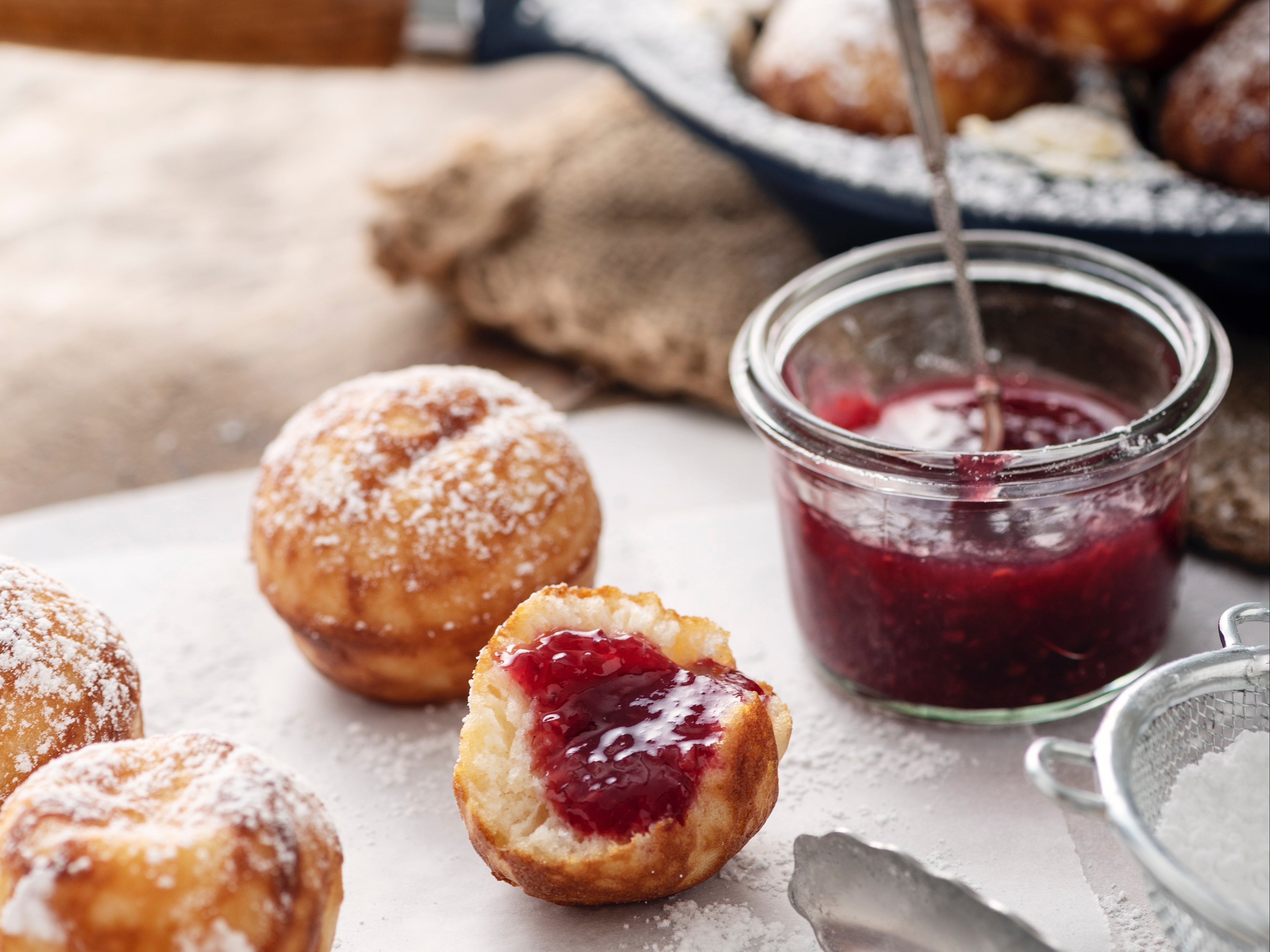 Æbleskiver, the traditional pancake balls covered with icing sugar and berry jam