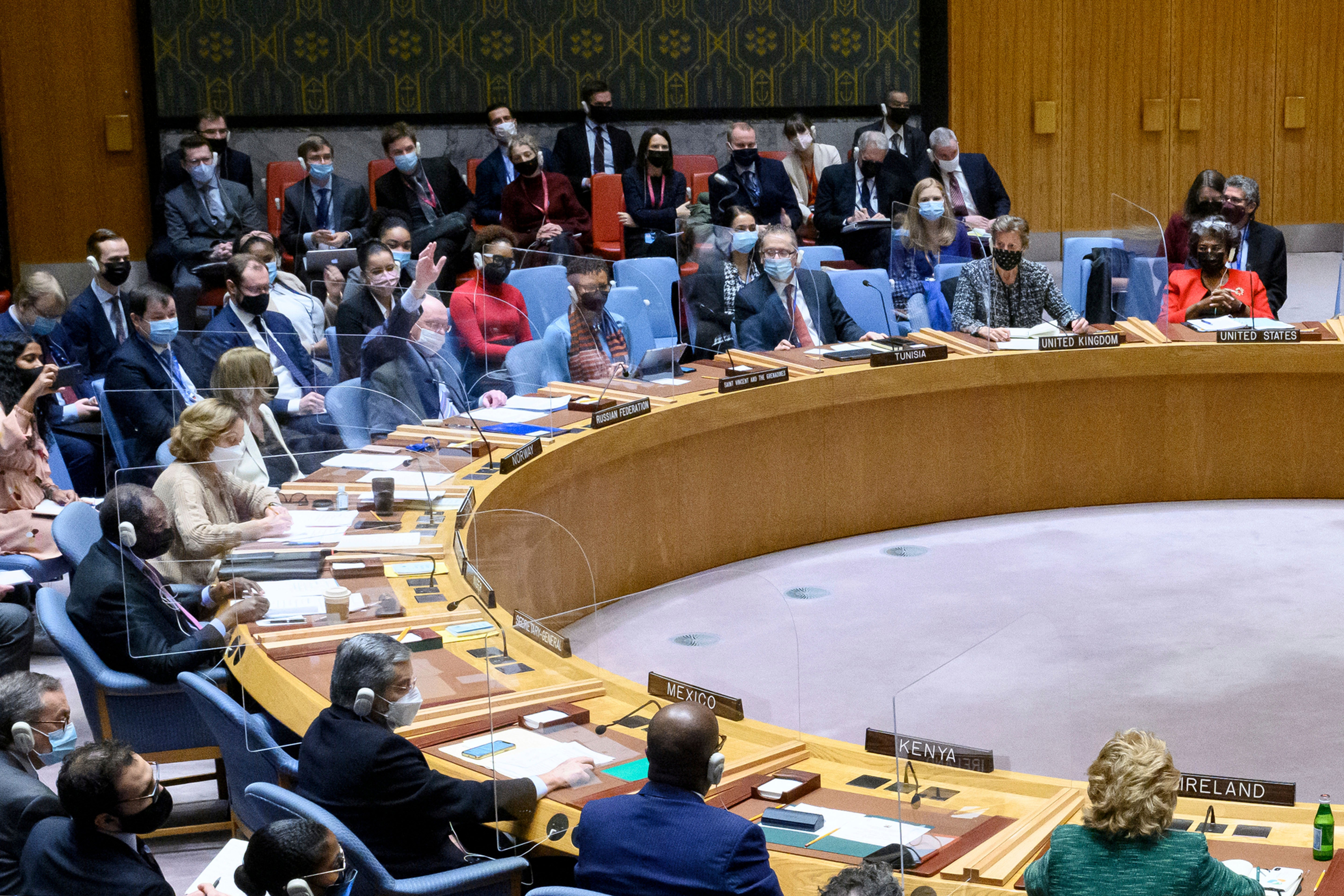 In this photo provided by the United Nations, Russian envoy Vassily Nebenzia (upper left) raises his hand to veto a first-of-its kind UN Security Council resolution casting climate change as a threat to international peace and security on 13 December 2021