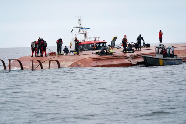<p>Divers work on the capsized Danish ship Karin Hoej after it collided with British vessel Scot Carrier in the Baltic Sea. </p>