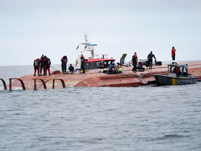 <p>Divers work on the capsized Danish ship Karin Hoej after it collided with British vessel Scot Carrier in the Baltic Sea. </p>