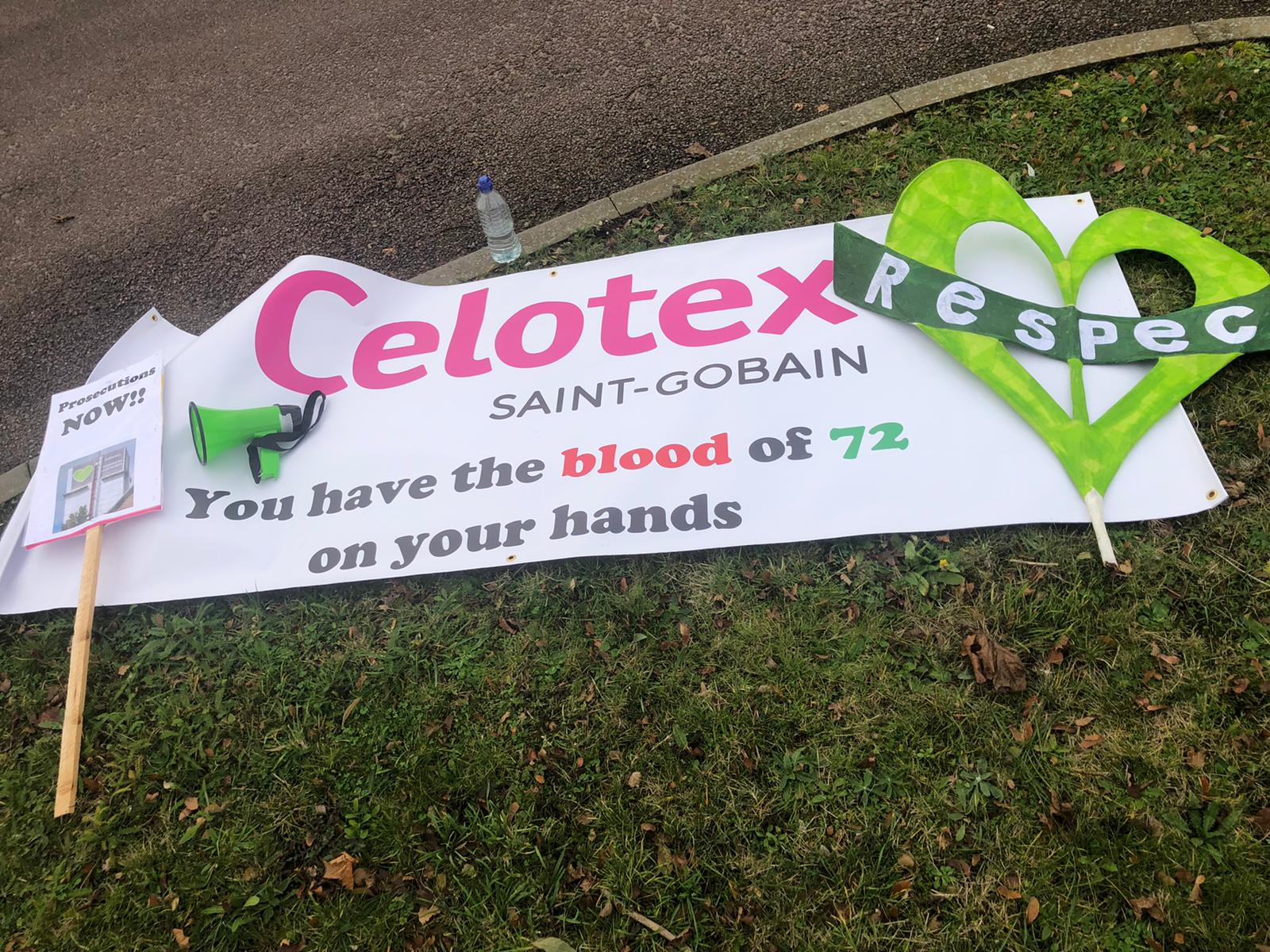 Protest banners read ‘Celotex you have the blood of 72 on your hands'