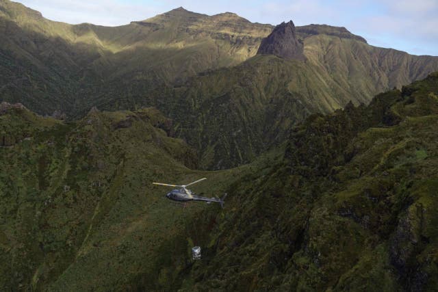 Helicopter spreading bait over Gough Island (RSPB/Michelle Risi/PA)