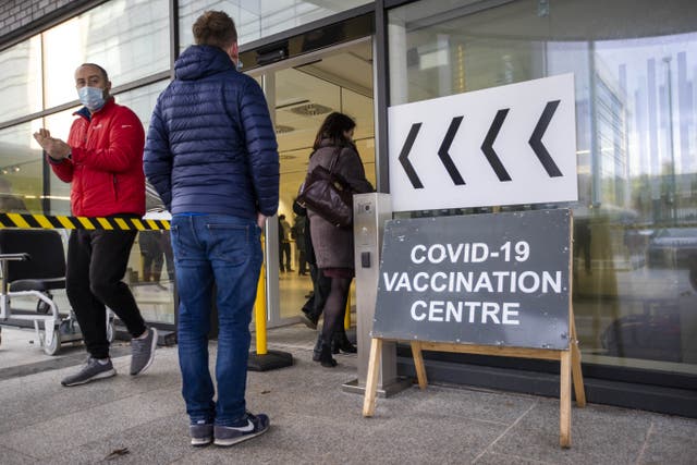 People queue at a Covid-19 vaccination centre at Dundonald Hospital in Belfast (Liam McBurney/PA)