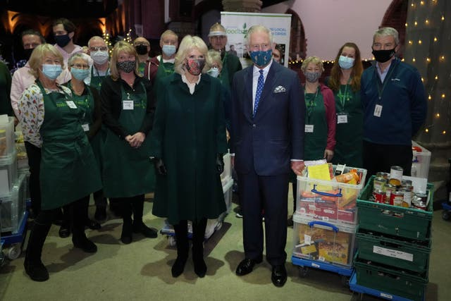 The Prince of Wales and Duchess of Cornwall with volunteers (Kirsty Wigglesworth/PA)
