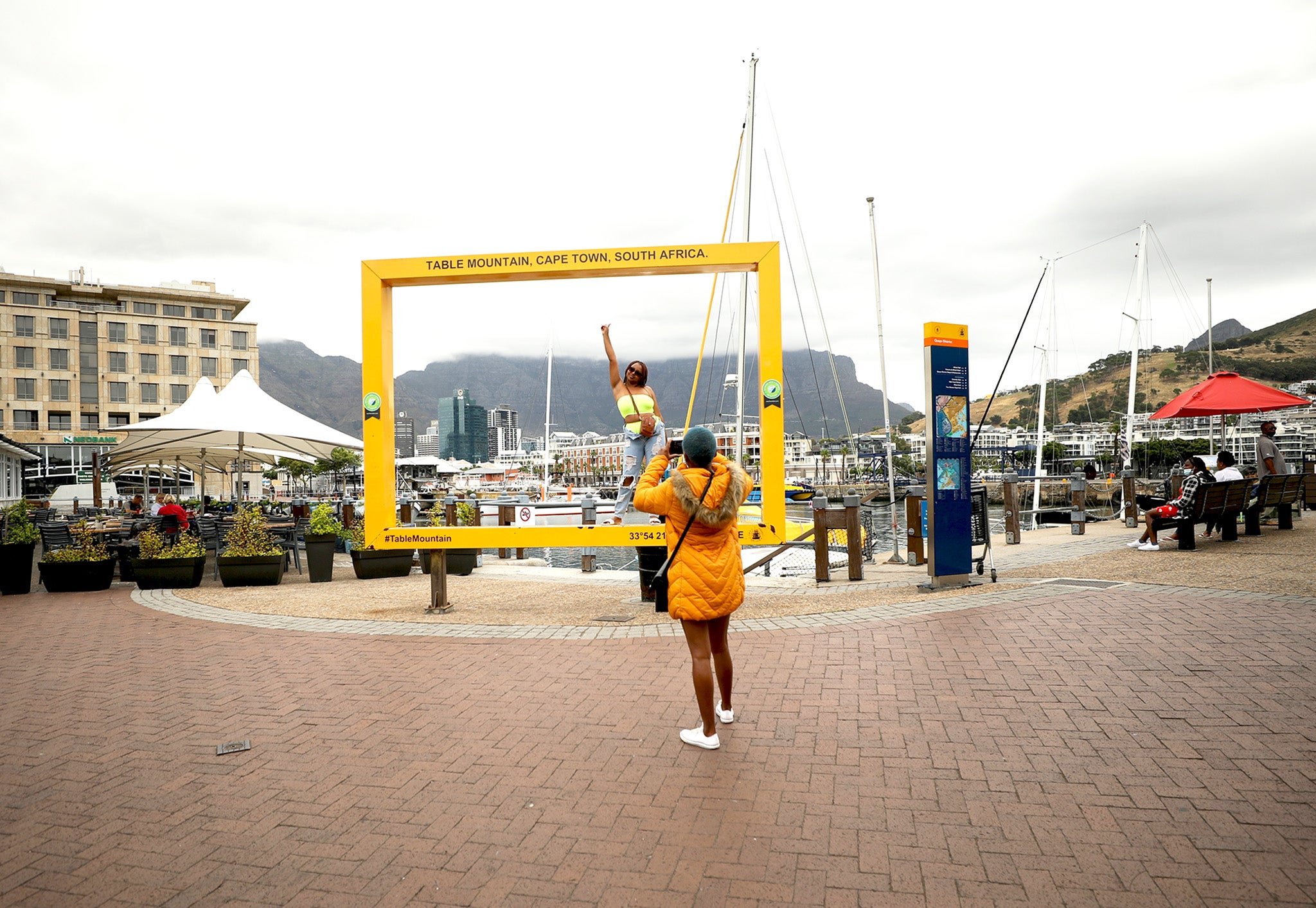 A visitor poses for pictures in the Waterfront district in Cape Town