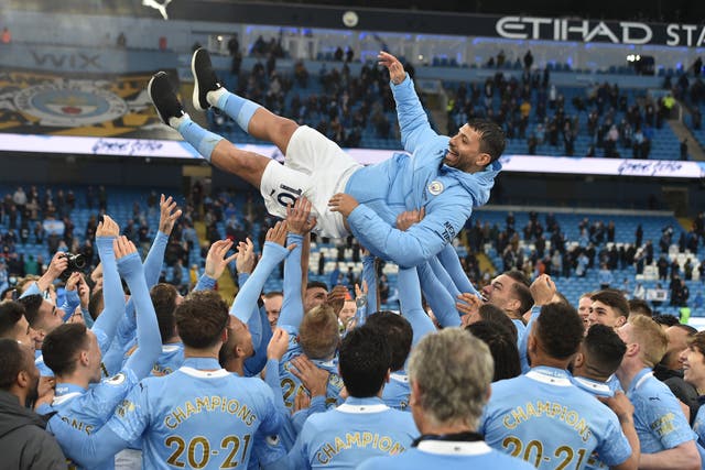 Sergio Aguero is thrown up in the air by team-mates (Peter Powell/PA)