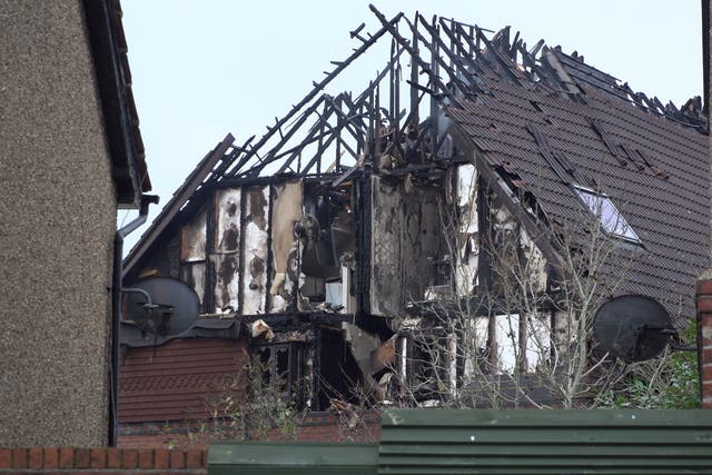 Damage to a property in Grovelands Road, Reading, where one person has died and others are “unaccounted for” in a large fire. Police have arrested a 31-year-old man on suspicion of murder and arson. Picture date: Wednesday December 15, 2021.