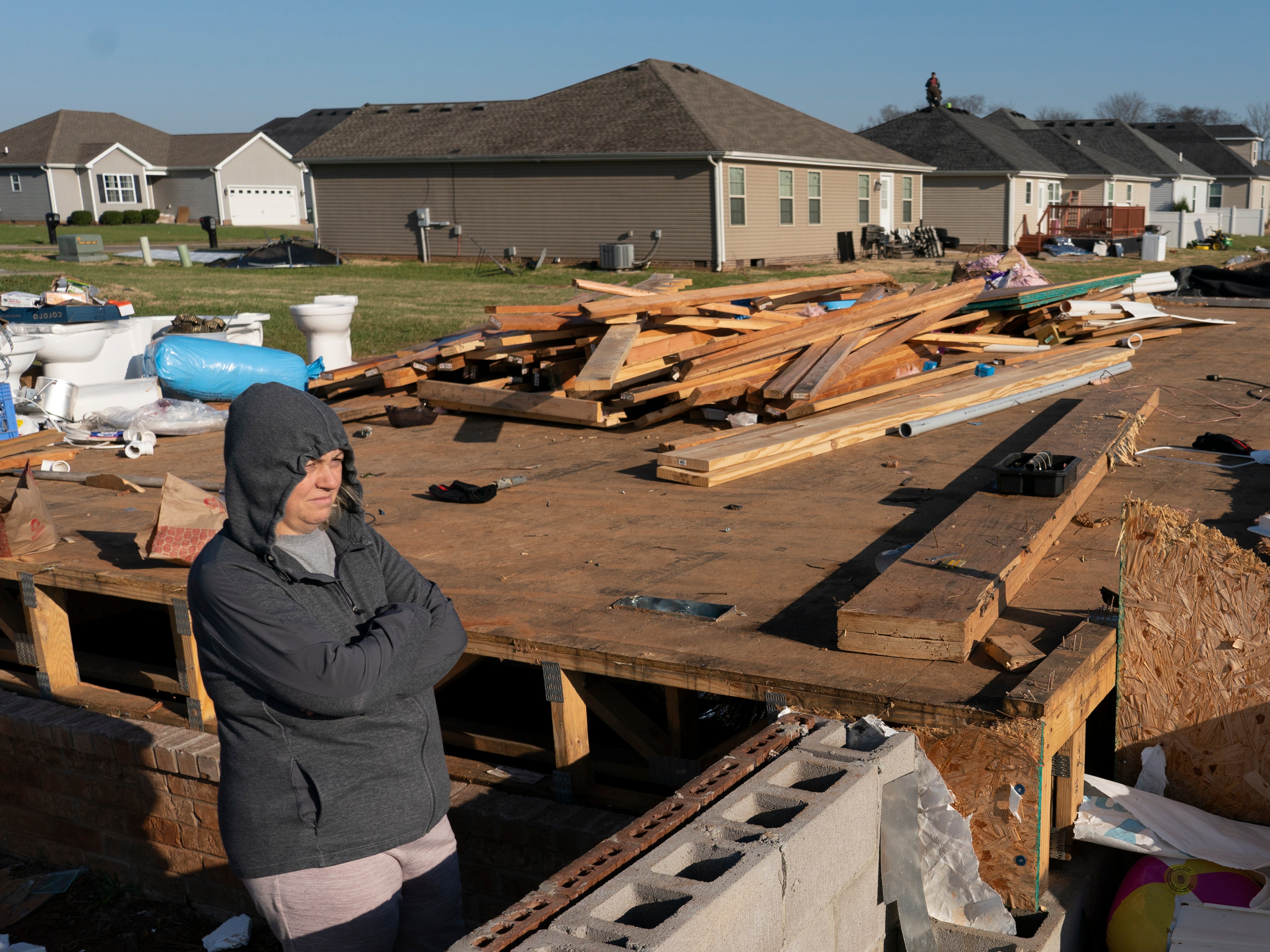 Ganimete Ademi surveys the debris from her daughter's house which was being built along Moss Creek Avenue in Bowling Green, Ky., Tuesday, Dec. 14, 2021