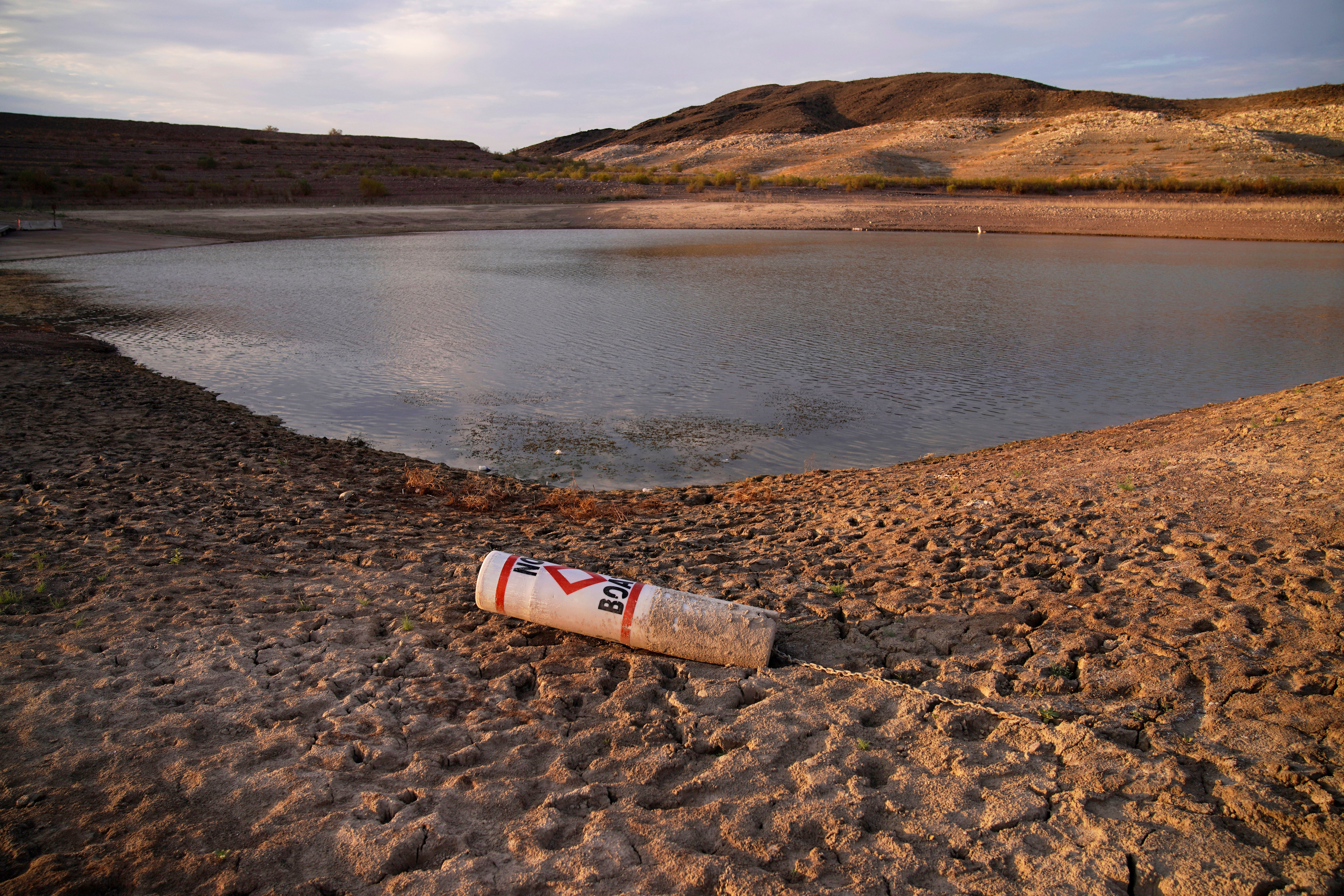 <p>A buoy rests on the ground at a closed boat ramp on Lake Mead near Boulder City, Nevada in August amid the megadrought in the US West</p>