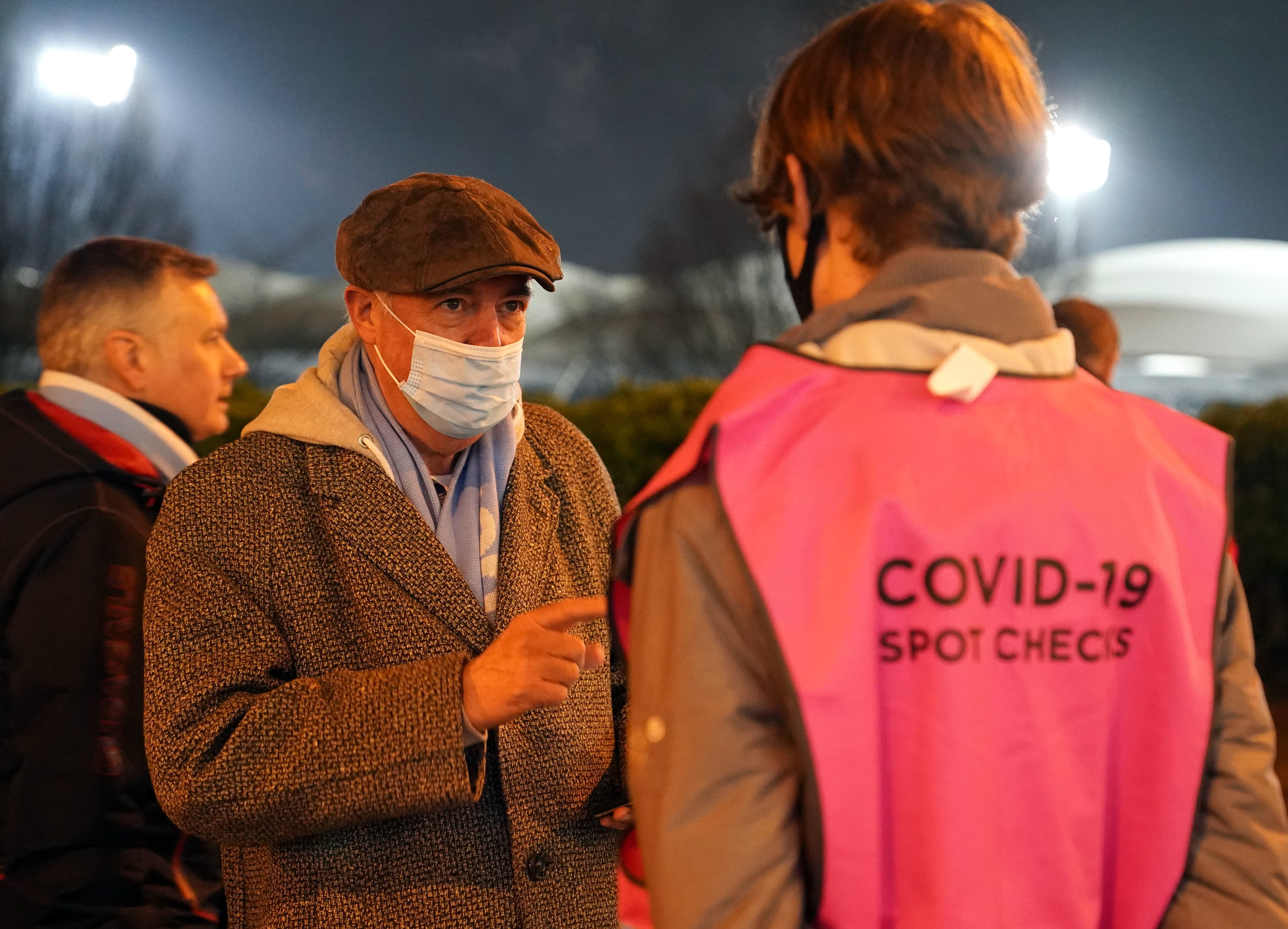 An arriving fan receives a Covid-19 spot check outside the stadium before the Premier League match between Manchester City and Leeds on Tuesday
