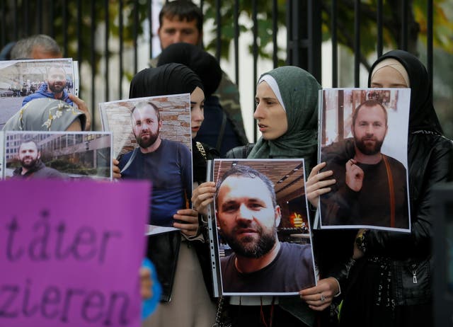 <p>File photo: People hold portraits of Zelimkhan Khangoshvili in front of the German embassy in Tbilisi, Georgia, in 2019</p>