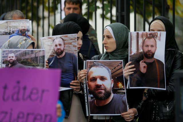 <p>File photo: People hold portraits of Zelimkhan Khangoshvili in front of the German embassy in Tbilisi, Georgia, in 2019</p>