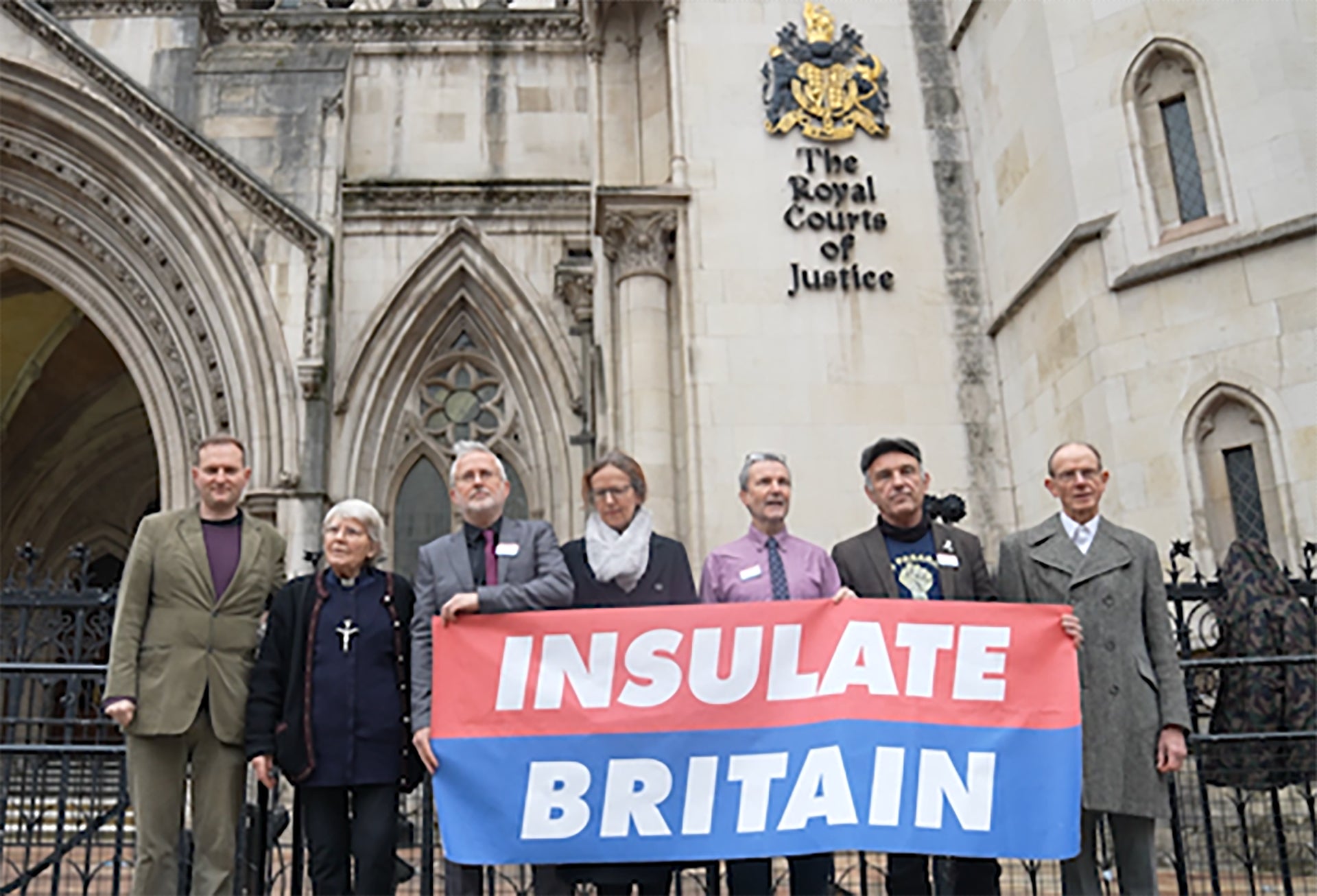 Screengrab taken from PA video of Insulate Britain supporters (L to R) Paul Sheeky ,Rev Sue Parfitt, Biff Whipster, Ruth Jarman, Steve Pritchard, Steve Gower, and Richard Ramsden outside the High Court (PA)