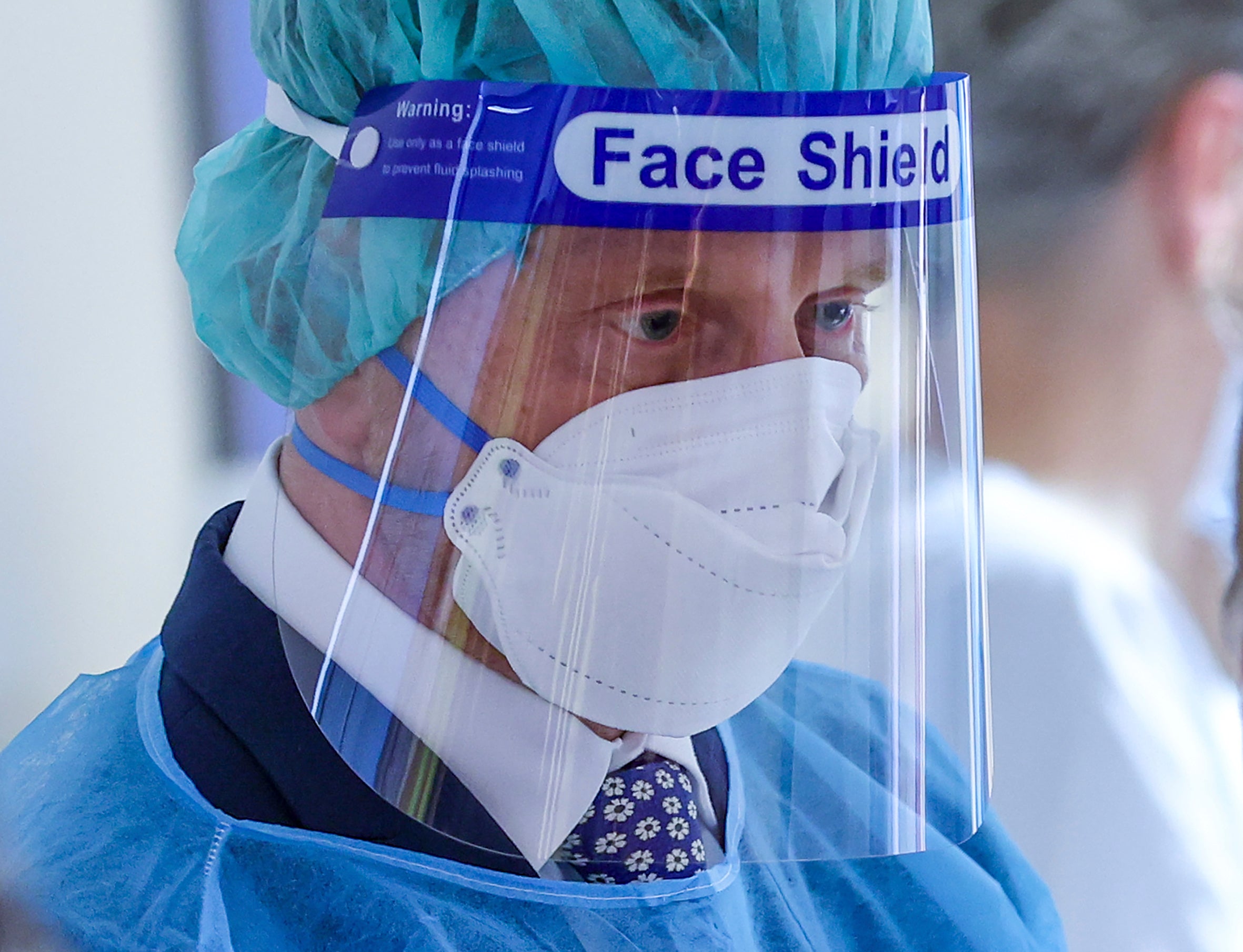 Michael Kretschmer, Prime Minister of Saxony, wearing a mask and face shield, visits the Covid standard ward at Leipzig University Hospital