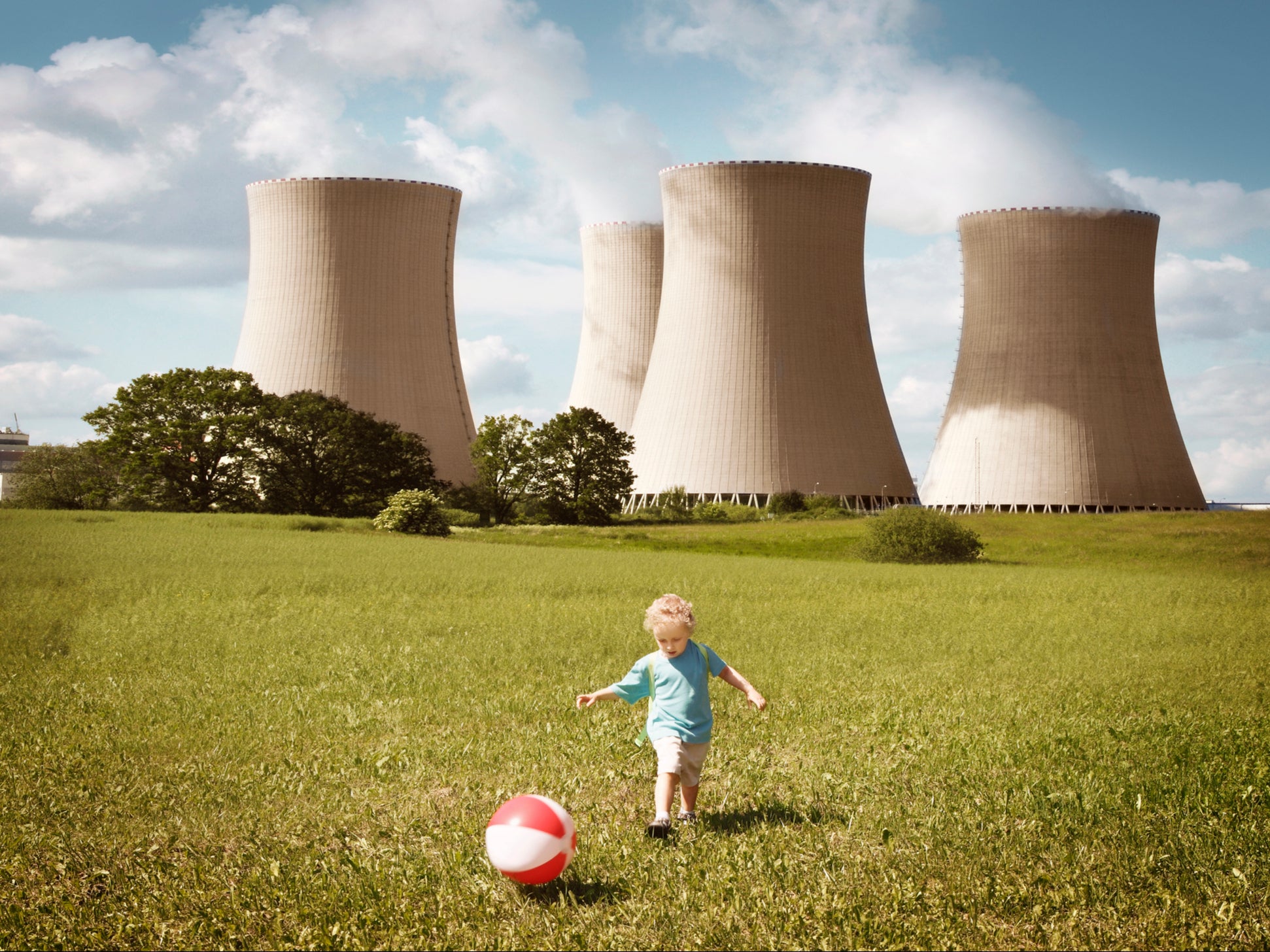 A child plays in front of cooling towers. Scientists have said fossil fuels are having a “major” negative impact on human reproductivity