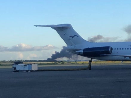 Smoke rises from the runway of Las Américas International Airport in Santo Domingo, Dominican Republican, where a private jet crashed on 15 December, 2021.