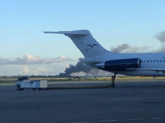 <p>Smoke rises from the runway of Las Américas International Airport in Santo Domingo, Dominican Republican, where a private jet crashed on 15 December, 2021.</p>