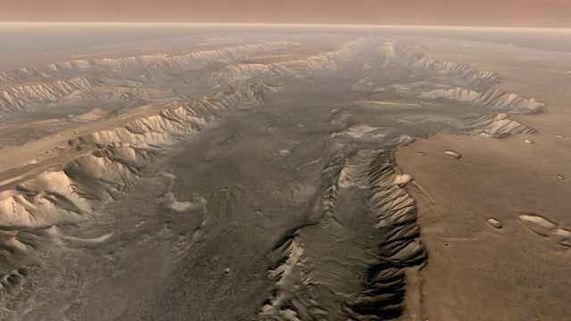 Mars’ own Grand Canyon, Valles Marineris, is shown on the surface of the planet in this composite image made aboard NASA’s Mars Odyssey spacecraft