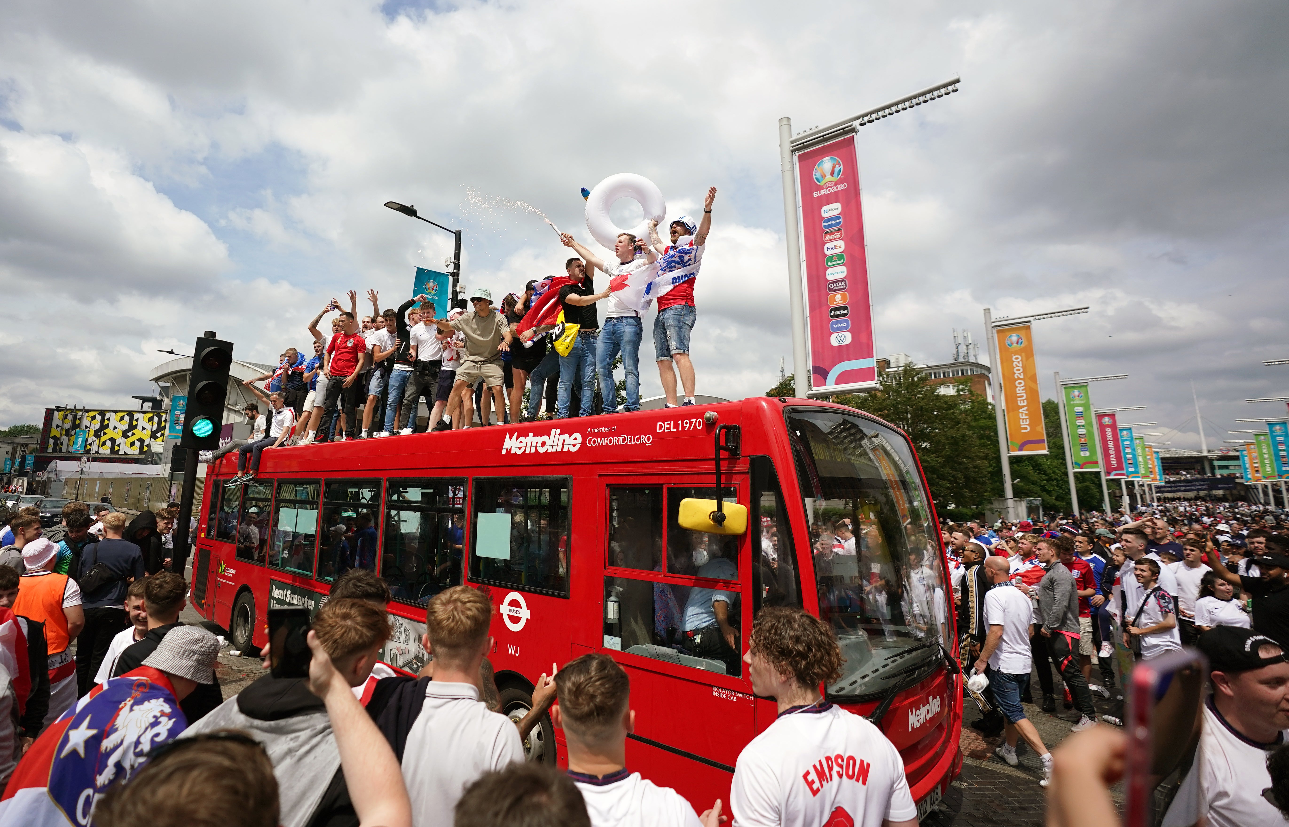 England fans climb aboard a bus outside the ground ahead of the Euro 2020 final at Wembley. The day was marred by crowd trouble with ticketless thugs storming into the stadium before kick-off (Zac Goodwin/PA)