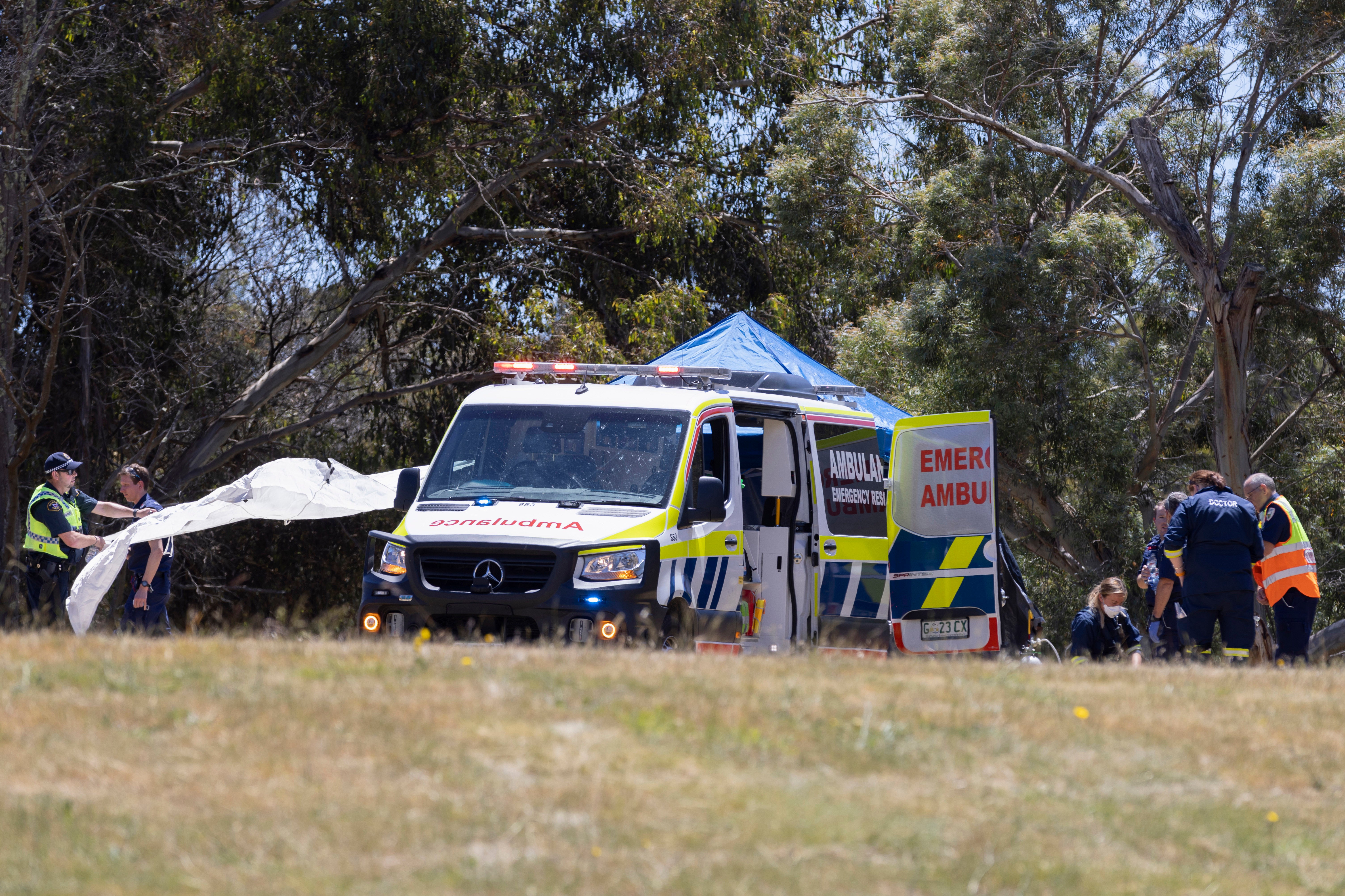 Emergency services personnel work at the scene of the deadly incident in Tasmania