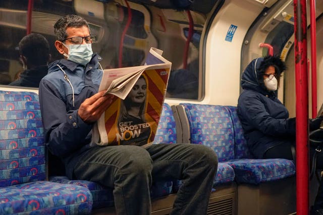 <p>People wearing face masks on the London Underground</p>