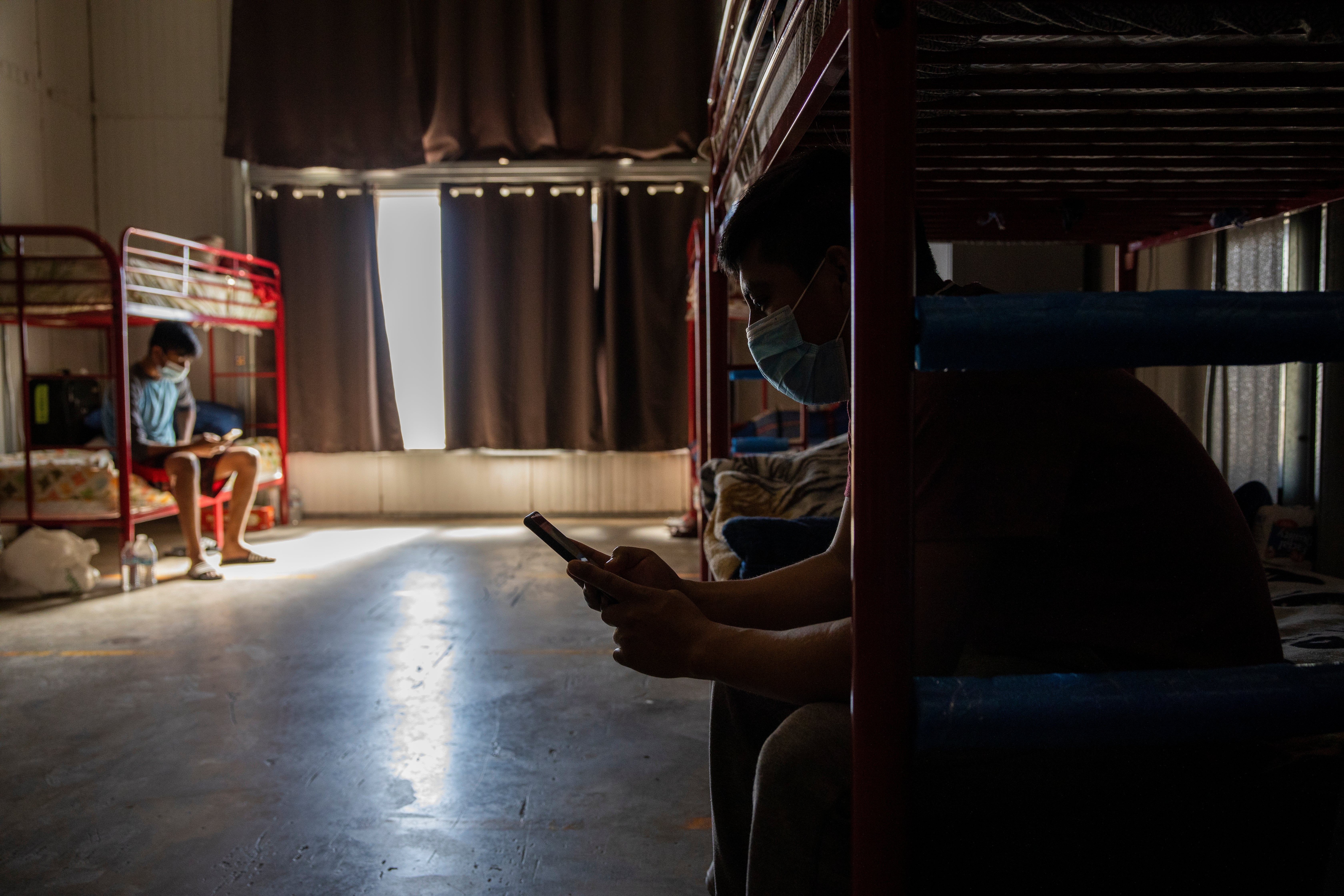 Migrant farm workers rest in their company dormitory in King City, California