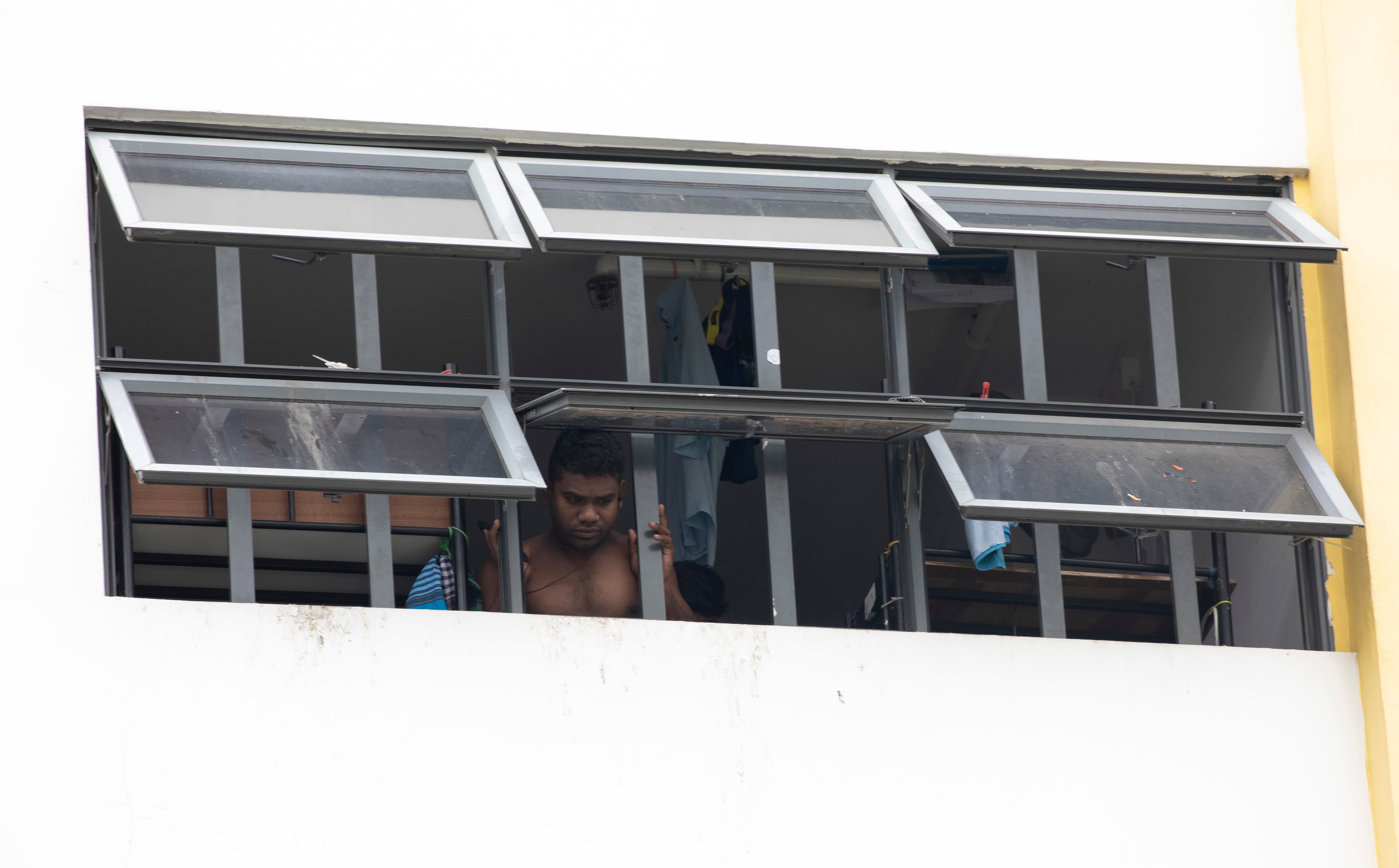 A migrant worker locked down in a dormitory in Singapore