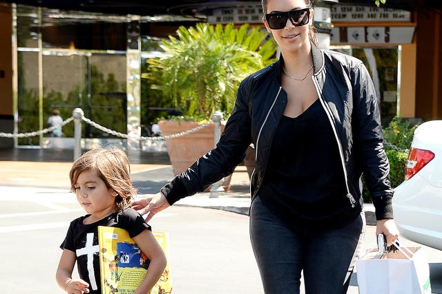 <p>Kim Kardashian and Mason Disick in California, 2014</p>