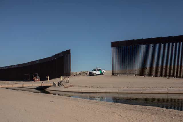 <p>A Customs and Border Protection vehicle waits for a group of  migrants as they walk towards the US-Mexico border</p>