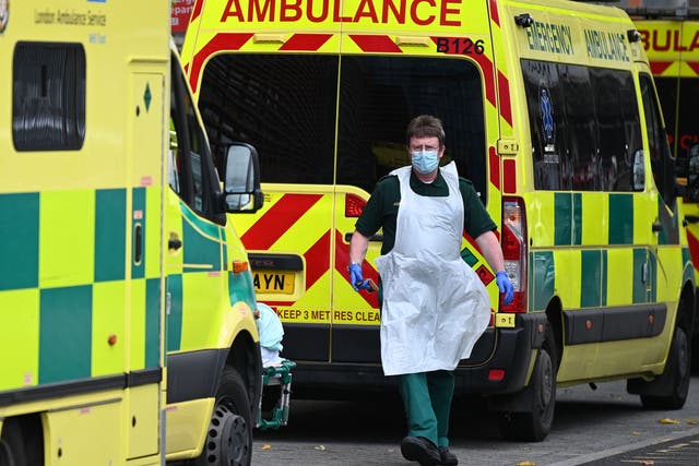 <p>A paramedic walks past ambulances outside the Royal London Hospital in east London</p>