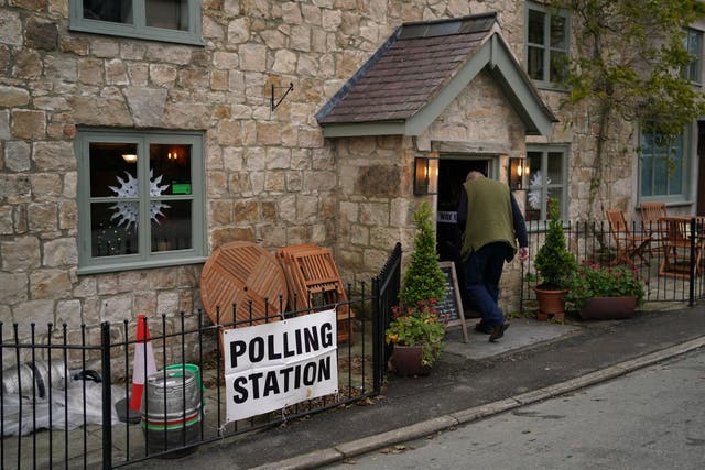 A man enters a polling station in the Docks public house on the outskirts of Oswestry, during voting for the North Shropshire by-election (Jacob King/PA)