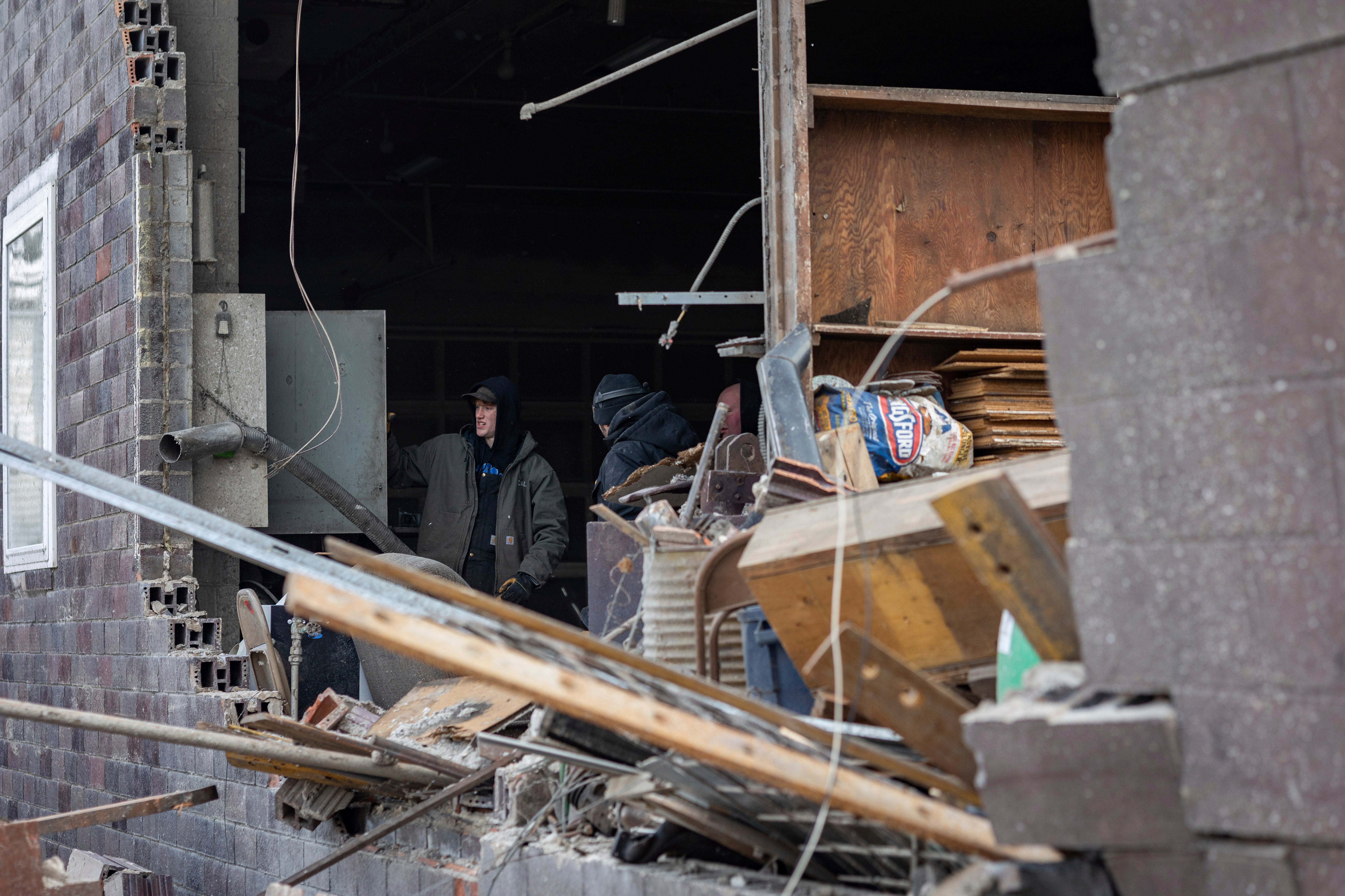 <p>People survey the damage after a strong thunderstorm swept through Hartland, Minnesota </p>
