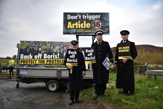 <p>Protesters dressed as customs officials man an unofficial checkpoint on the Irish border</p>