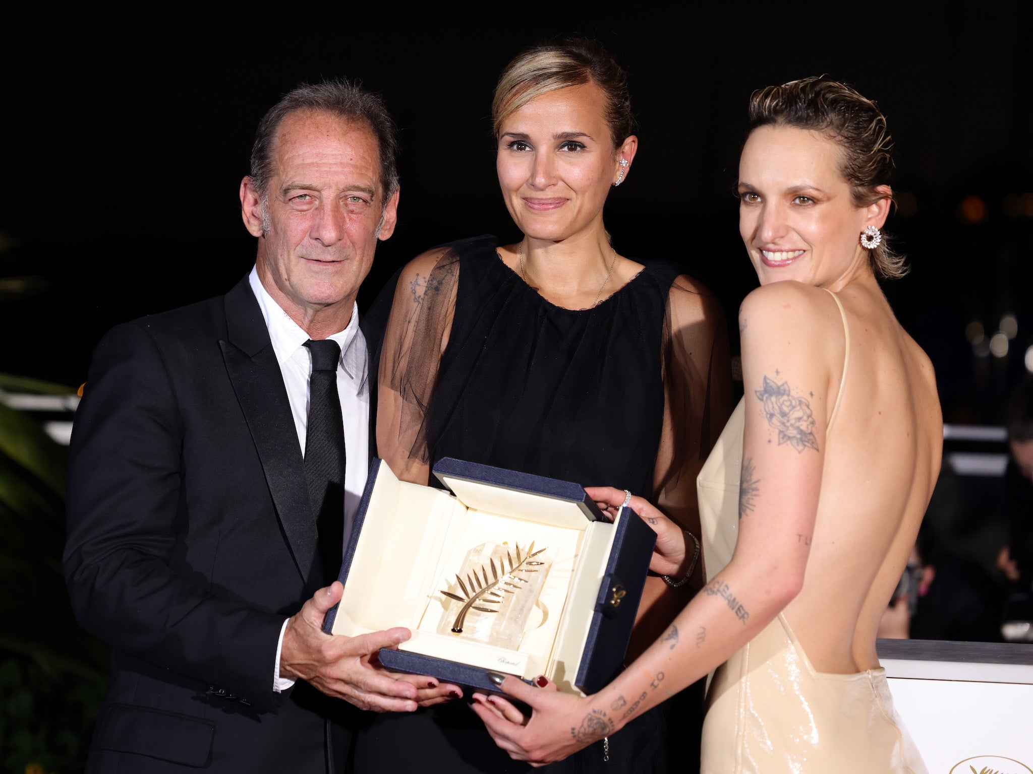 Vincent Lindon, Julia Ducournau and Agathe Rousselle pictured with the prestigious Palme d’Or prize at Cannes Film Festival 2021