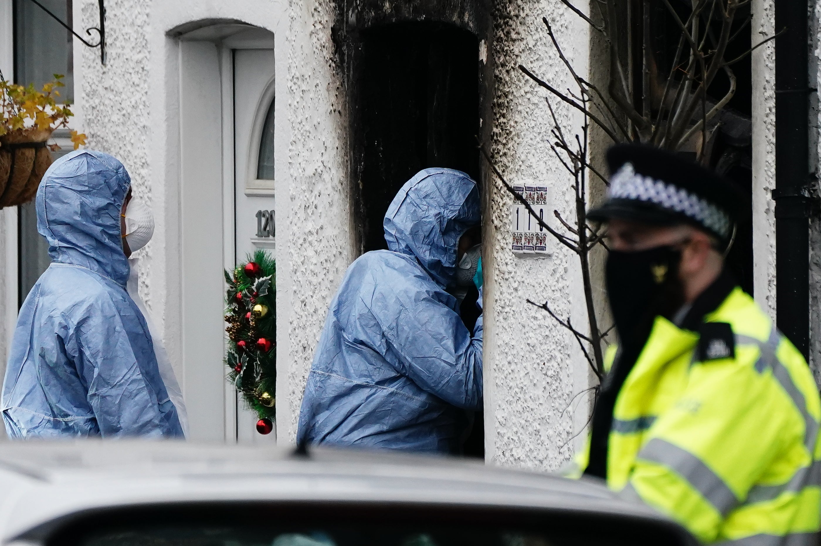 Forensic investigators at the scene in Collingwood Road, Sutton, south London