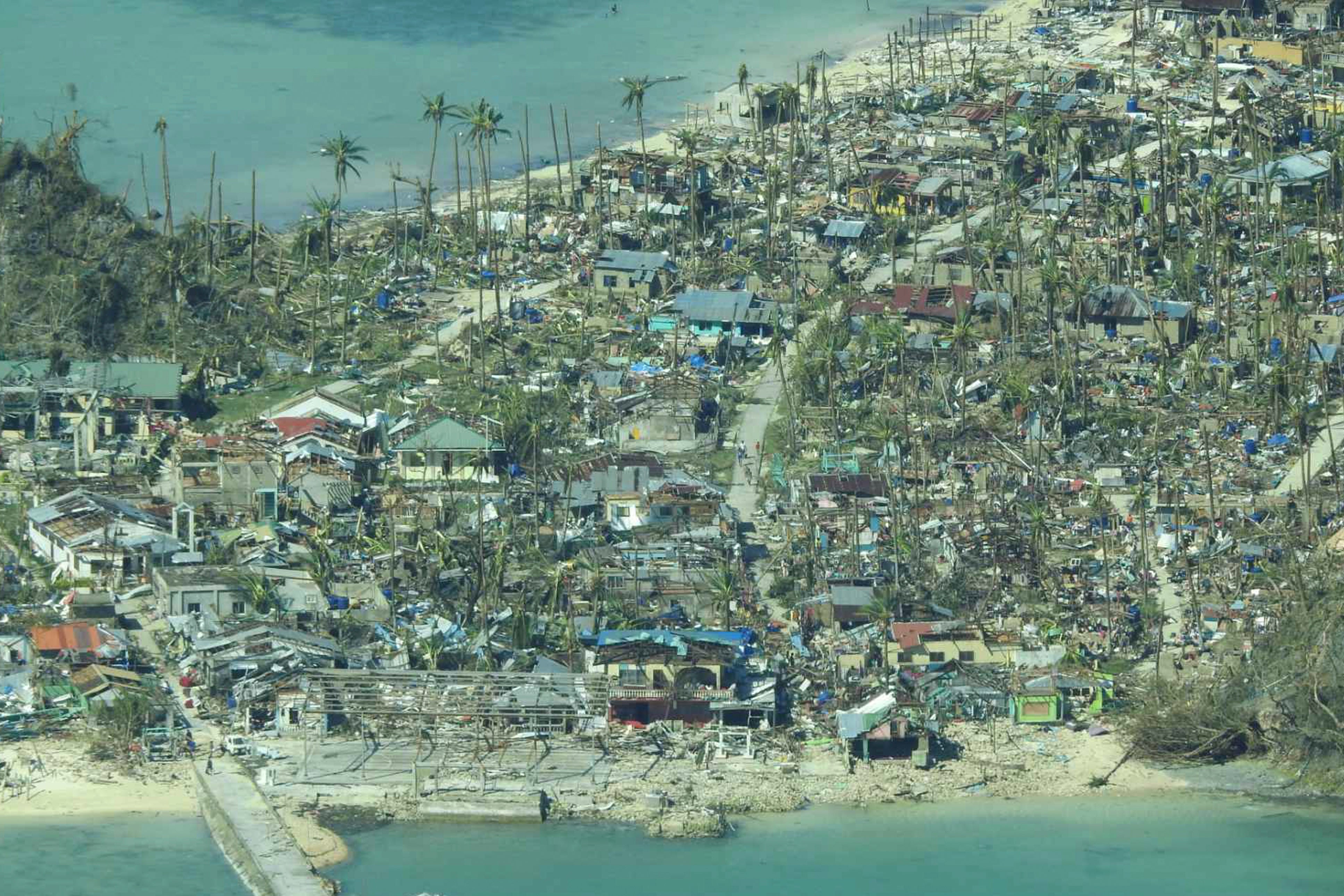 Damaged houses caused by Typhoon Rai at a coastal village in Surigao del Norte province