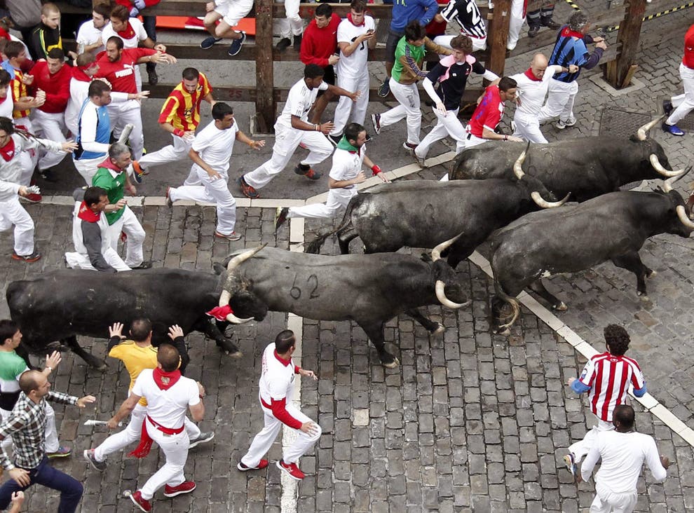 Several ‘mozos’ or runners are chased by bulls in Pamplona in 2016