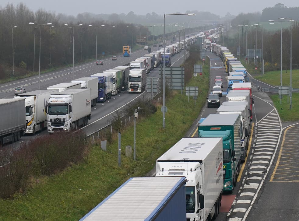 Freight lorries had to queue on the M20 motorway in Kent heading to Dover (left) and at the entrance to the Channel Tunnel (right) on Saturday (Gareth Fuller/PA)