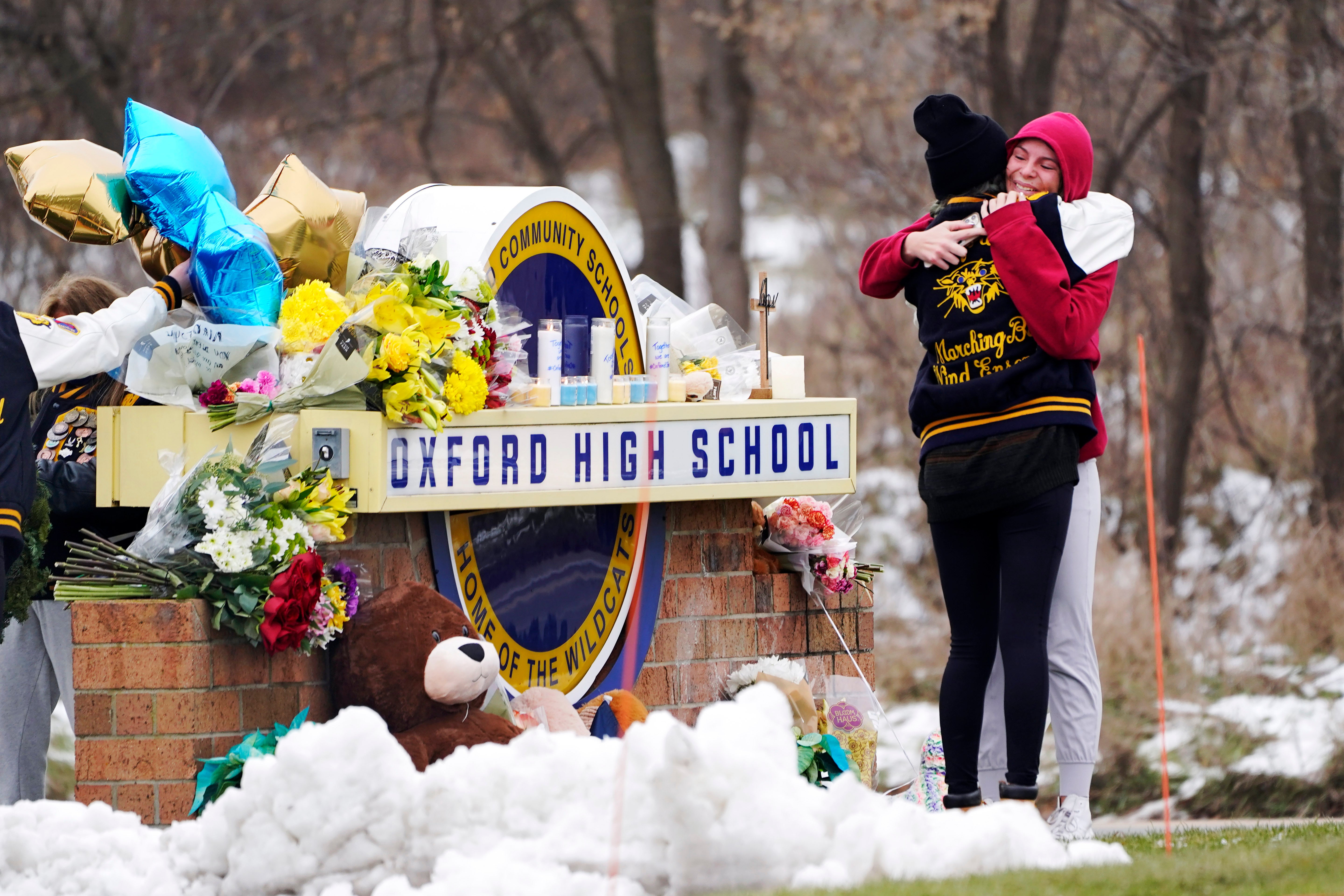Students comfort each other outside Oxford High School after the mass shooting