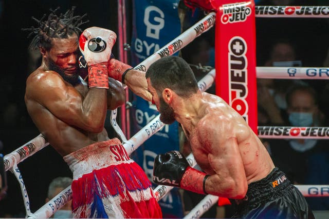 <p>Artur Beterbiev, right, throws a punch at Marcus Browne</p>