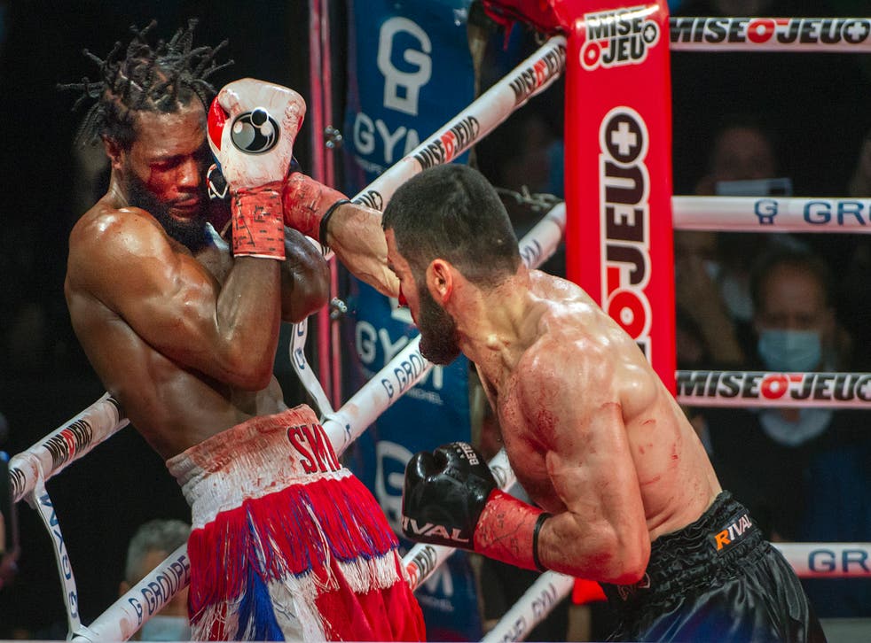 <p>Artur Beterbiev, right, throws a punch at Marcus Browne</p>