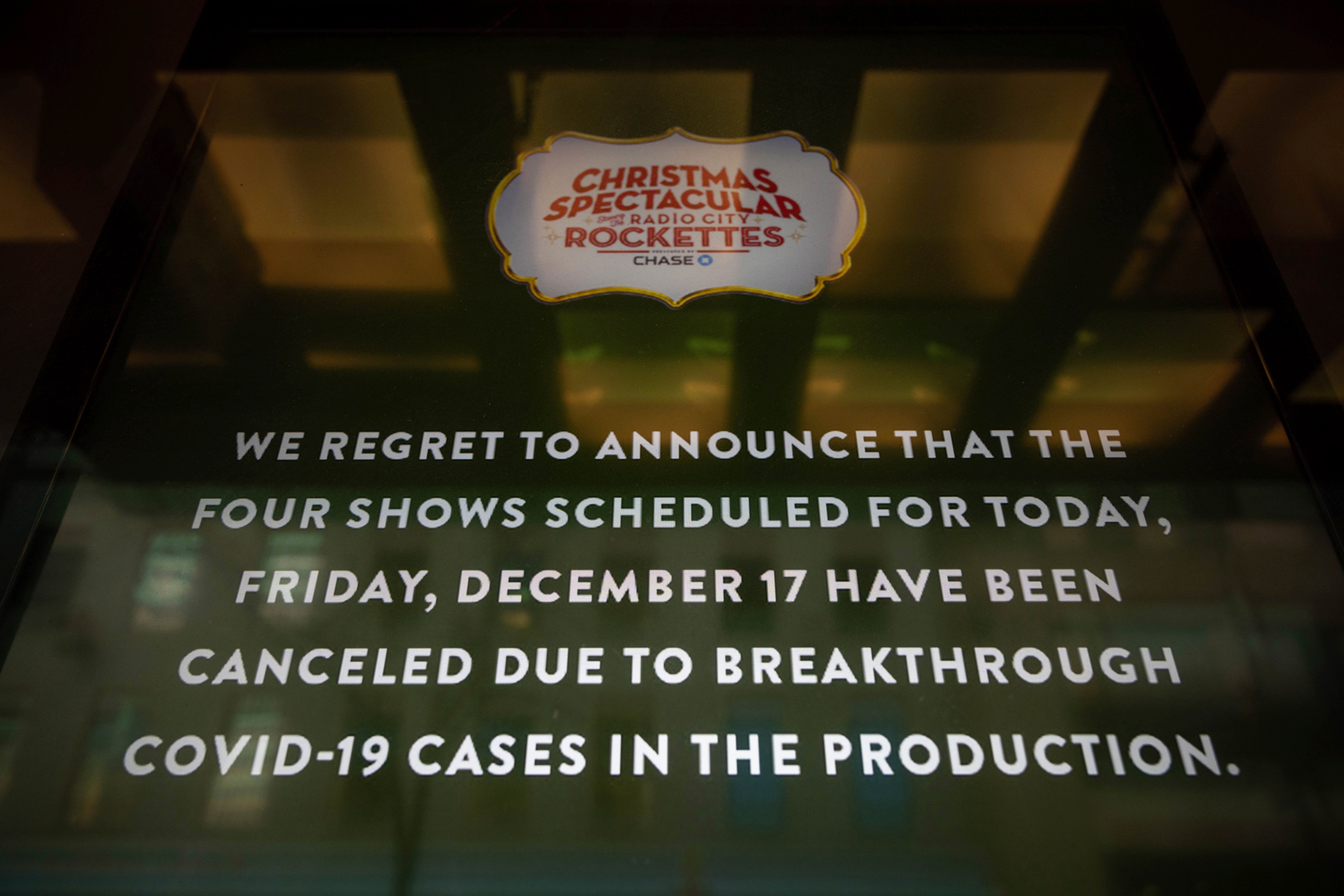 A screen announces cancellations of The Rockettes performance due to COVID-19 cases on December 17