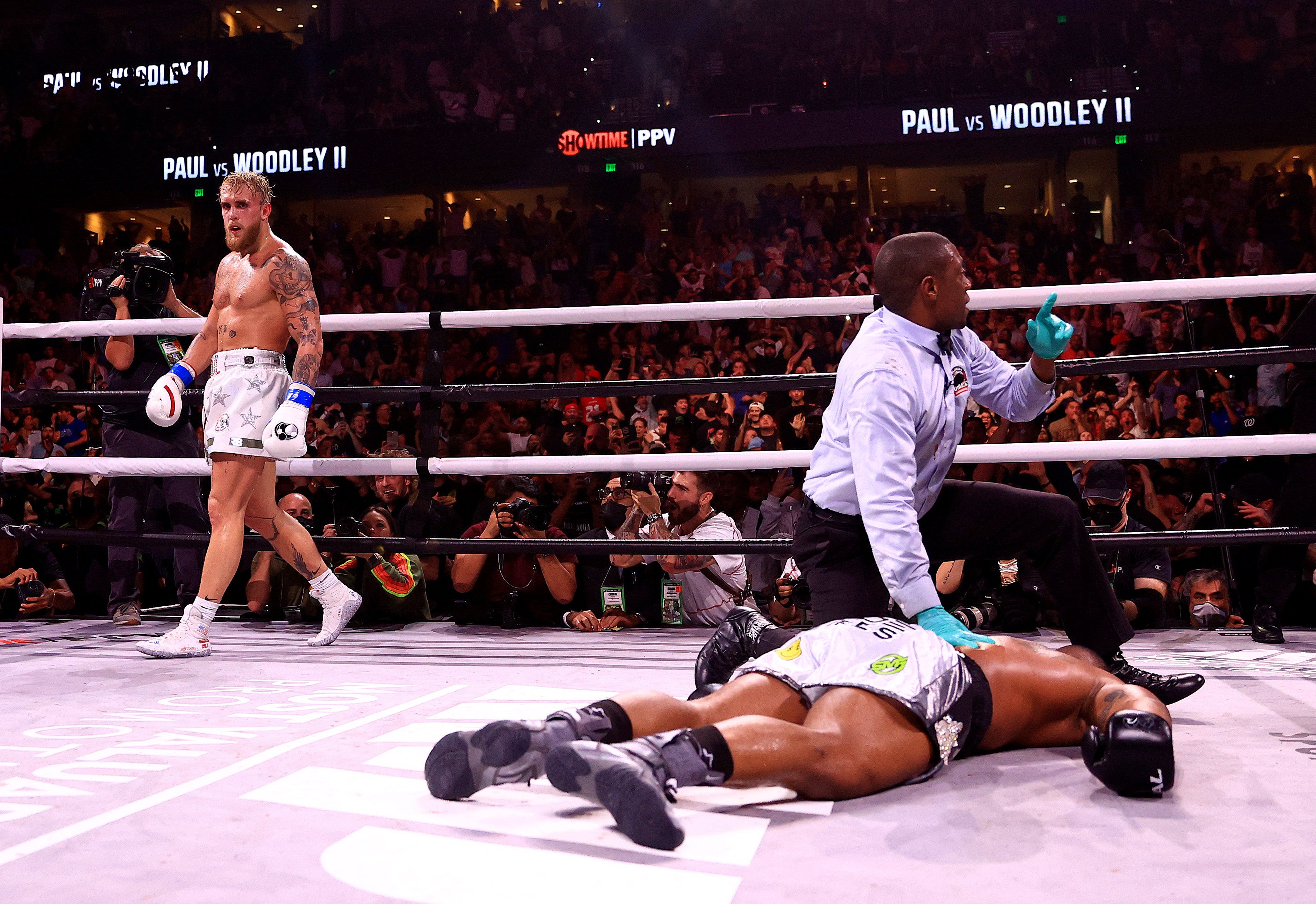 Jake Paul looks on after inflicting a devastating knockout on Tyron Woodley