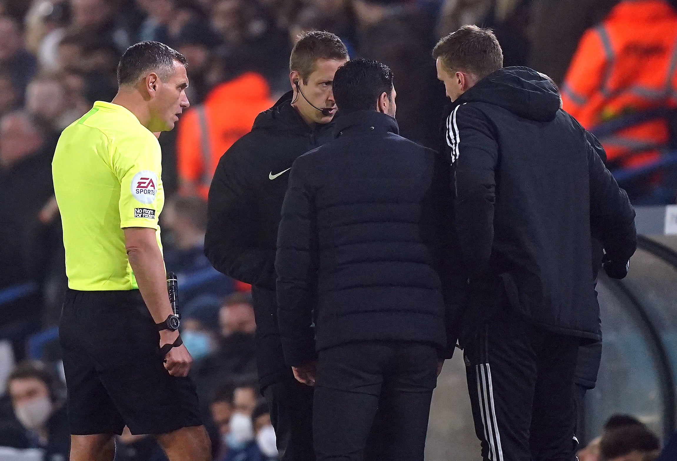 Referee Andre Marriner (left) spoke to the Arsenal bench after an alleged incident of racism during the game at Leeds (Mike Egerton/PA)