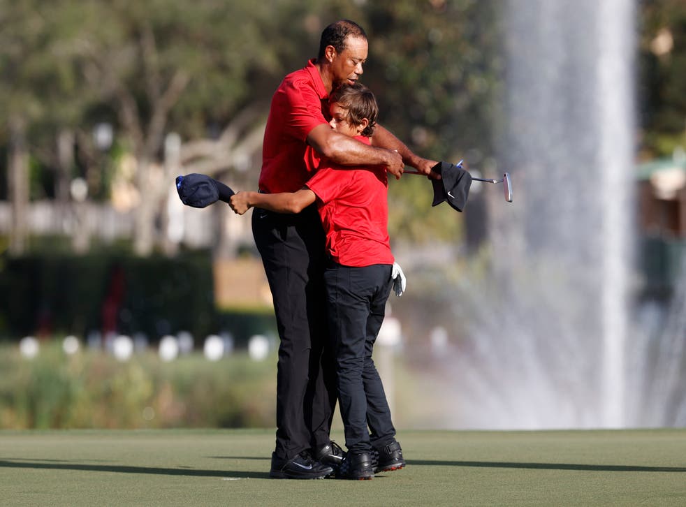 Tiger Woods hugs son Charlie Woods on the 18th green (Scott Audette/PA)