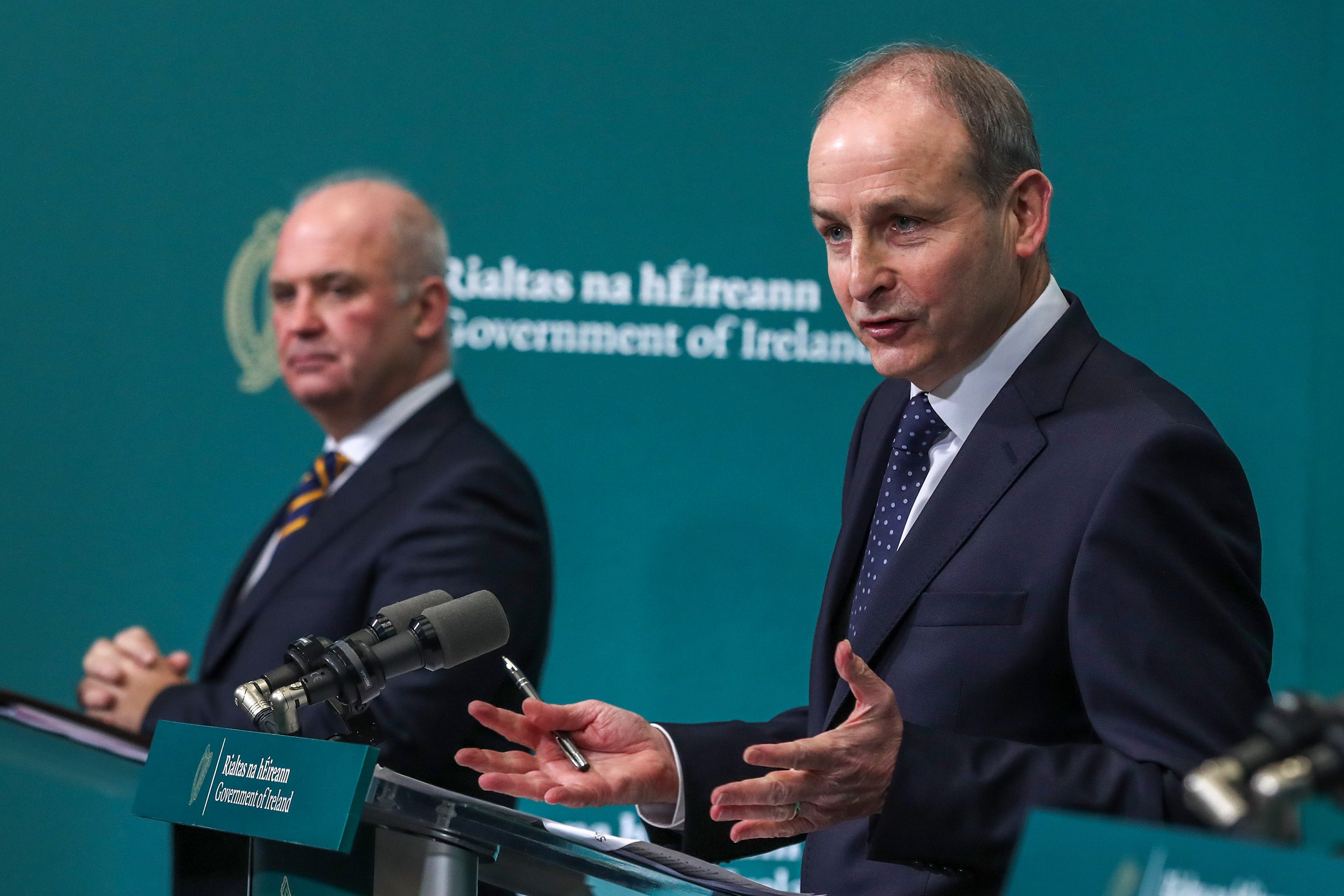 Dr Tony Holohan, the chief medical officer, and Taoiseach Micheal Martin (right) speaking to the media on Friday (Julien Behal/PA)