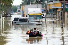 Rescue workers in Malaysia free people trapped by flooding