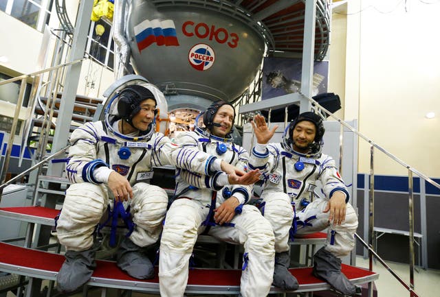<p>Russian cosmonaut Alexander Misurkin (centre) and Japanese space flight participants, billionaire Yusaku Maezawa (left) and his assistant Yozo Hirano, pictured in Moscow on 14 October</p>