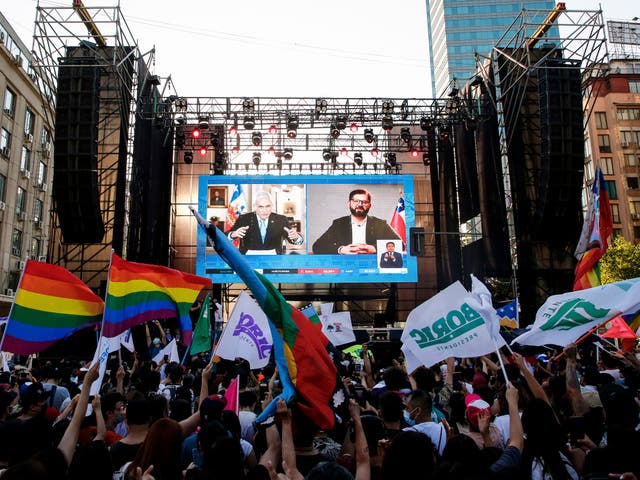 <p>Supporters of Gabriel Boric watch his videoconference with Sebastian Piñera after the runoff</p>