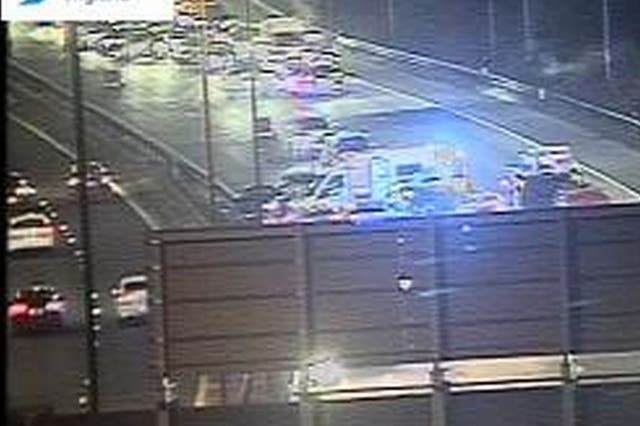 <p>Traffic camera footage shows the emergency services blocking the entire carriageway on Sunday evening as they responded to the crash</p>